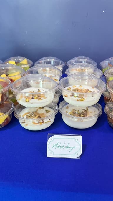 Mahalabiya cups garnished with pistachio for an office event in Qatar