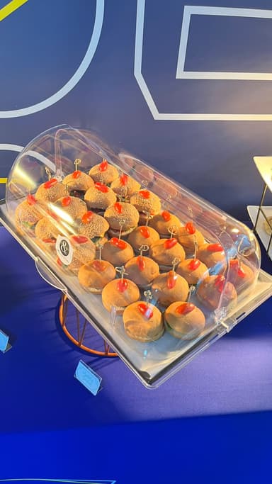 Savoury mini buns under a buffet dome at a Qatar office event